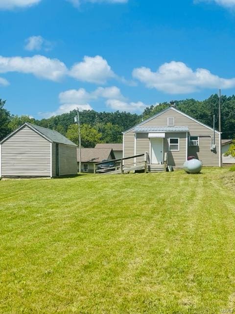 back of house with a lawn