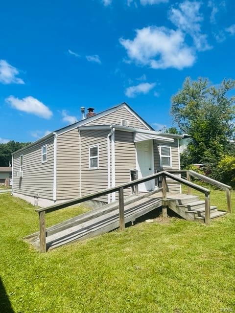 back of property featuring a yard and a deck