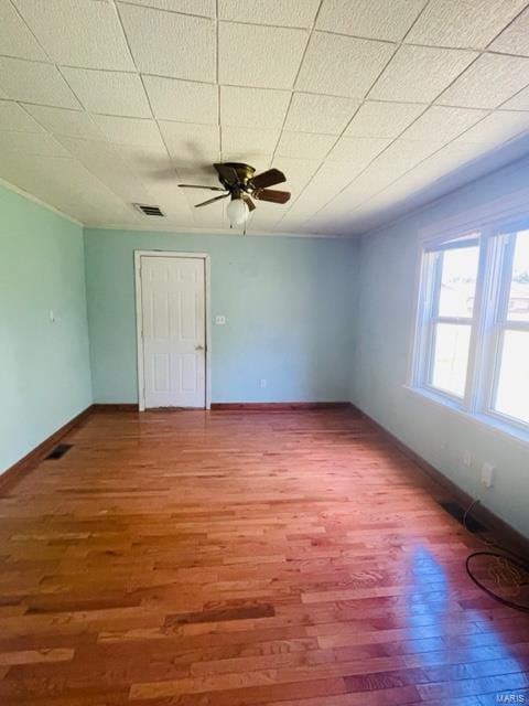 unfurnished room featuring hardwood / wood-style floors and ceiling fan