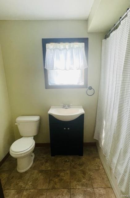 bathroom featuring vanity and toilet