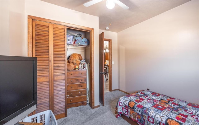 carpeted bedroom featuring a closet and ceiling fan