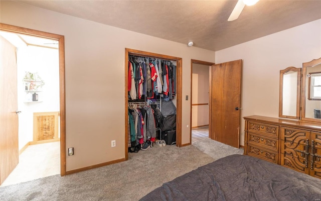 carpeted bedroom with ceiling fan and a closet