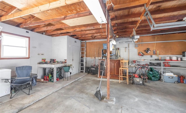 garage with a workshop area and a garage door opener