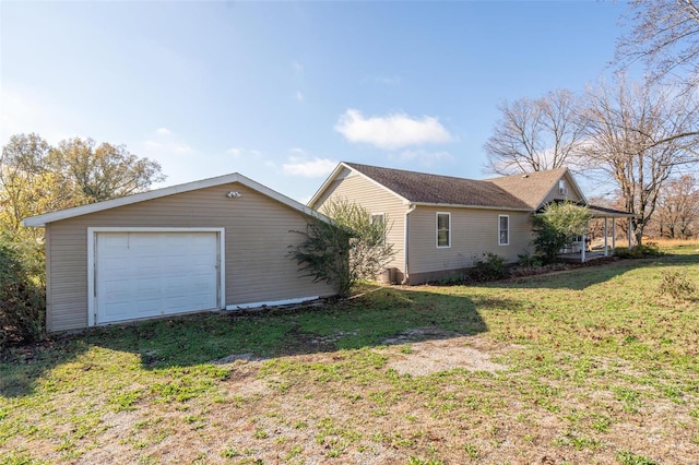 view of side of home with a yard and a garage