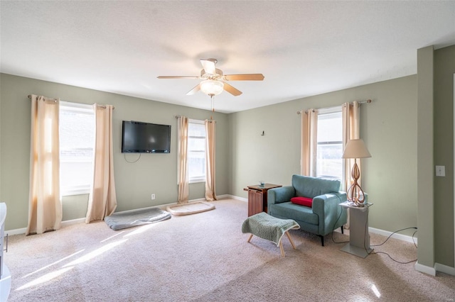 sitting room with light carpet and ceiling fan