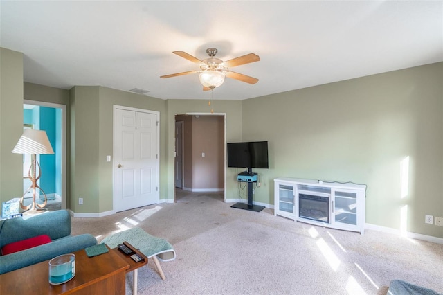 living room with light carpet and ceiling fan