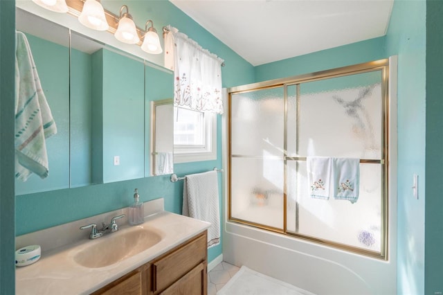 bathroom with combined bath / shower with glass door, vanity, and tile patterned floors