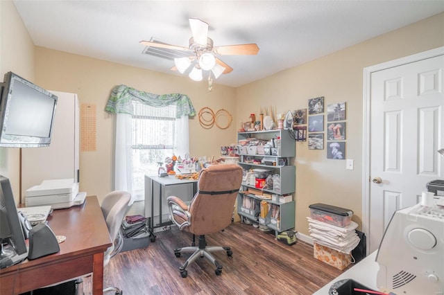 home office with dark hardwood / wood-style floors and ceiling fan