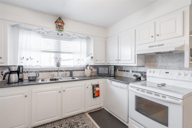 kitchen with decorative backsplash, white cabinetry, white appliances, and sink