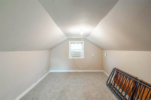 bonus room featuring carpet flooring, cooling unit, a textured ceiling, and vaulted ceiling