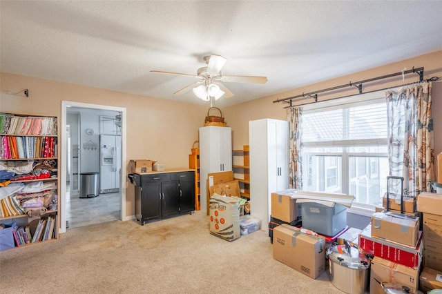 interior space with ceiling fan, light colored carpet, and a textured ceiling