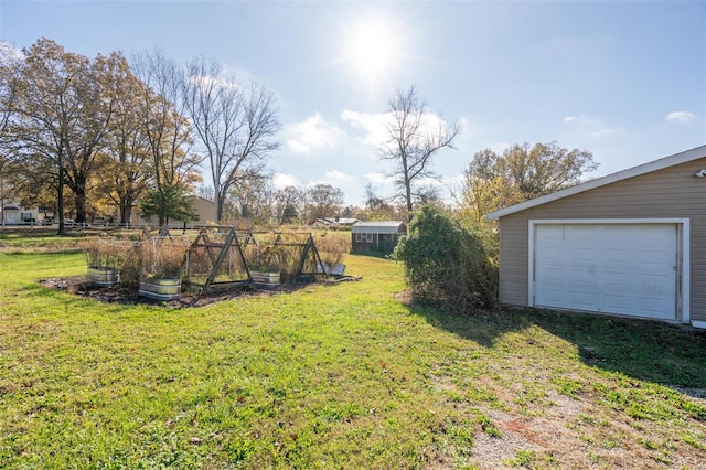 view of yard with a garage and an outdoor structure