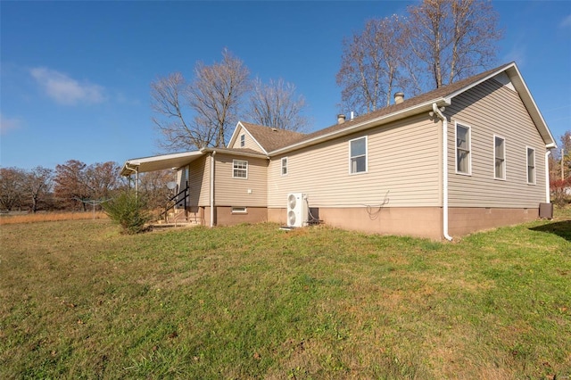 rear view of house featuring a lawn