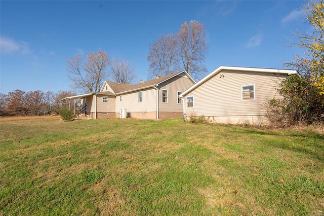 rear view of property featuring a yard