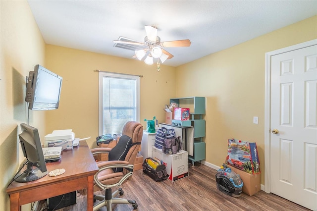 home office featuring a ceiling fan, baseboards, and wood finished floors