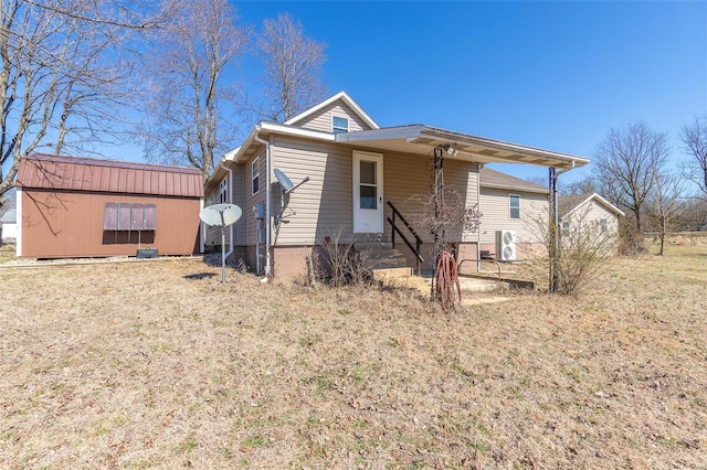 view of front of home featuring entry steps and an outdoor structure