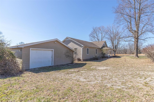 view of front of home with a front yard and a detached garage