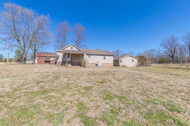 rear view of property featuring a yard