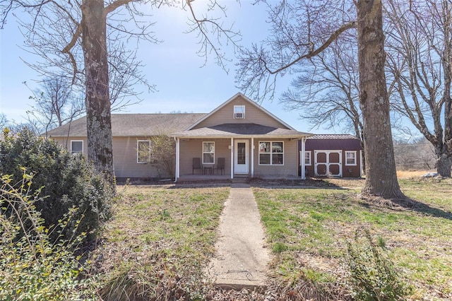 view of front of home with covered porch and a front yard