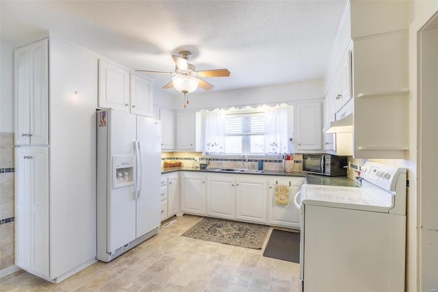 kitchen with white refrigerator with ice dispenser, stove, a sink, black microwave, and under cabinet range hood