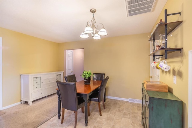 dining room with baseboards, visible vents, and a chandelier