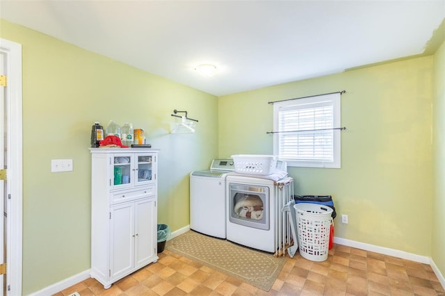 laundry room featuring baseboards and washer and dryer