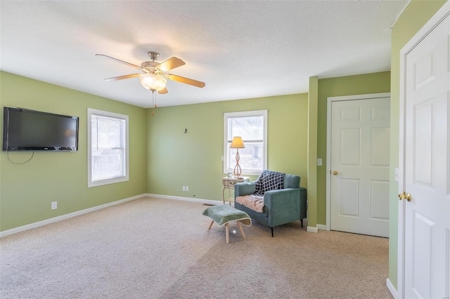 living area with carpet, plenty of natural light, and baseboards