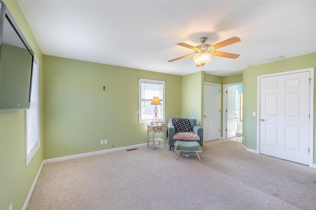 unfurnished room featuring carpet flooring, ceiling fan, visible vents, and baseboards