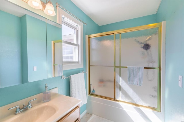 full bathroom featuring bath / shower combo with glass door and vanity