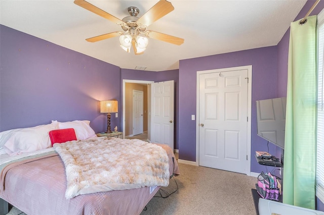 bedroom with baseboards, ceiling fan, visible vents, and light colored carpet