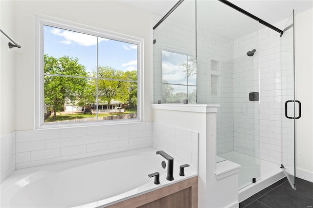 bathroom featuring tile patterned flooring, a healthy amount of sunlight, and separate shower and tub