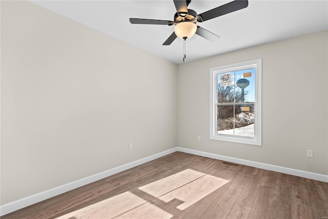 unfurnished room with hardwood / wood-style floors and ceiling fan