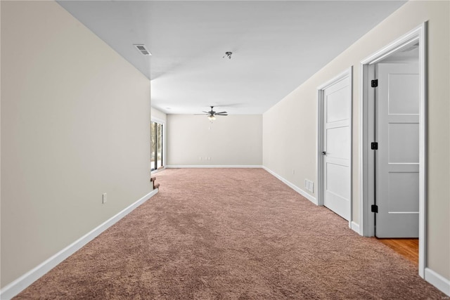 unfurnished room featuring light carpet and ceiling fan