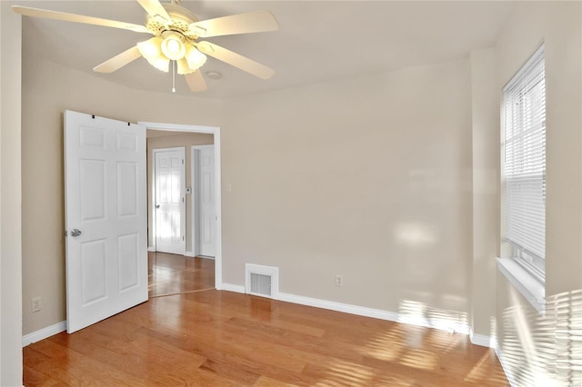 spare room featuring light hardwood / wood-style floors and ceiling fan