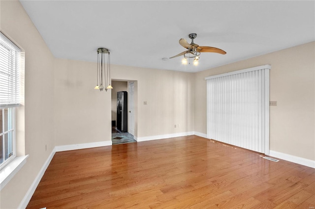 spare room featuring ceiling fan and light hardwood / wood-style floors