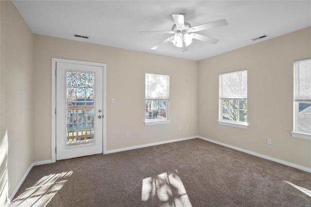 carpeted empty room with ceiling fan and a healthy amount of sunlight