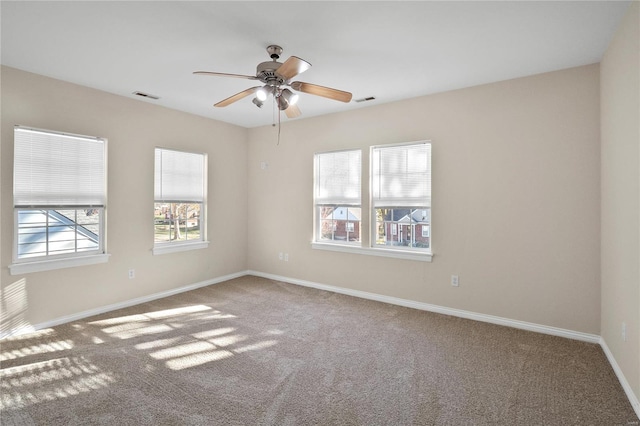 carpeted spare room with ceiling fan