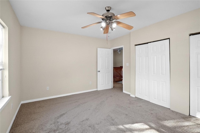 unfurnished bedroom featuring ceiling fan and carpet floors