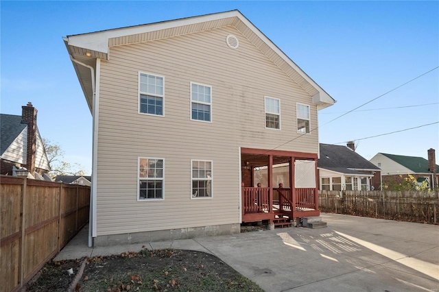 back of house with a patio and a wooden deck