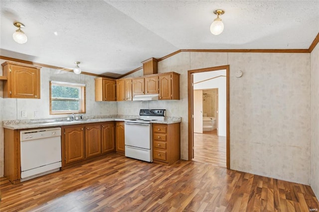 kitchen with dark hardwood / wood-style floors, white appliances, a textured ceiling, and vaulted ceiling