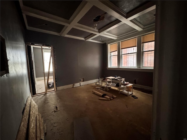 unfurnished room with beamed ceiling and coffered ceiling