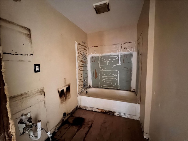 bathroom featuring wood-type flooring and a bath