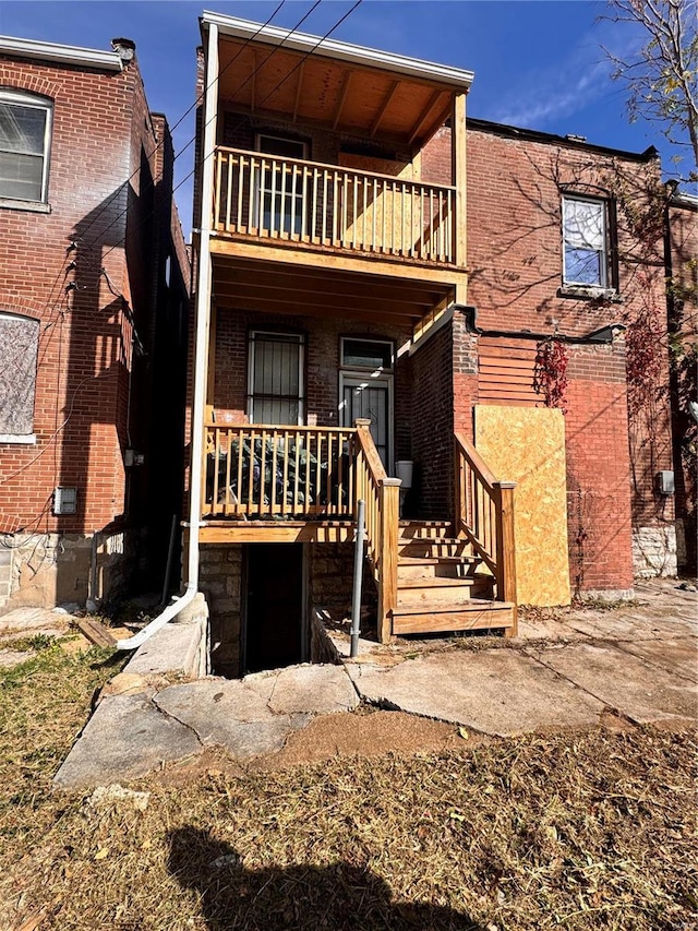 back of house with a balcony