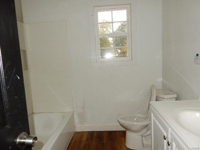 full bathroom with hardwood / wood-style flooring, vanity, toilet, and bathtub / shower combination