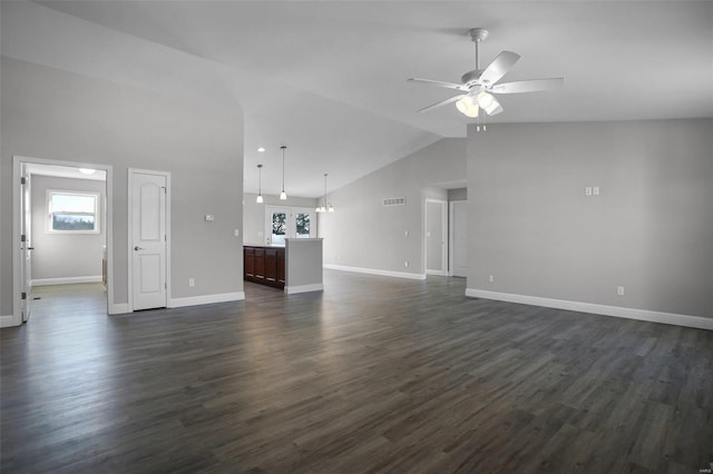 unfurnished living room featuring dark wood-type flooring, ceiling fan, and a wealth of natural light