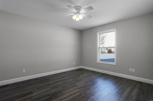 spare room with ceiling fan and dark wood-type flooring