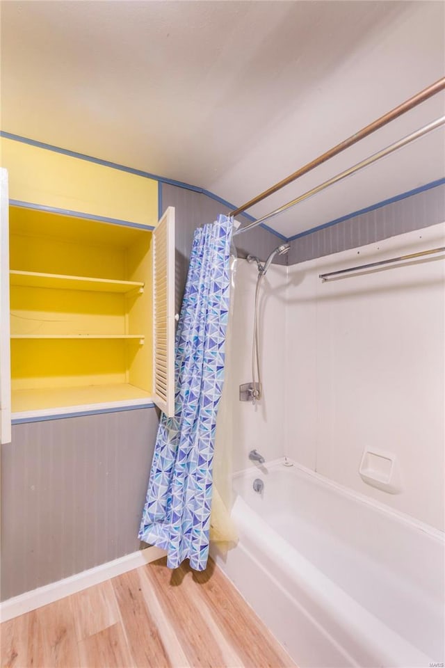 bathroom featuring shower / bath combination with curtain and hardwood / wood-style flooring