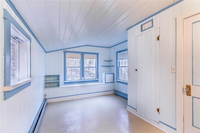 spare room featuring wooden walls, a baseboard radiator, lofted ceiling, and wooden ceiling