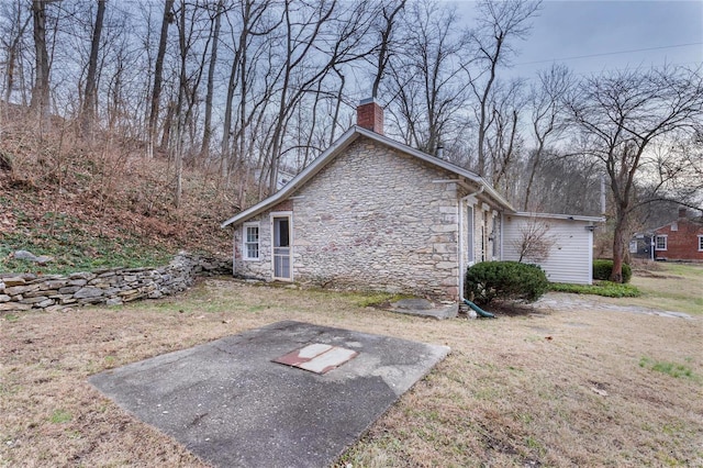 view of side of home with a lawn