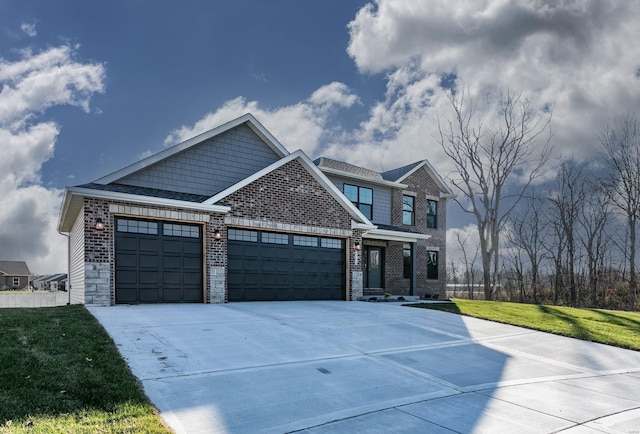 craftsman house featuring a garage and a front yard